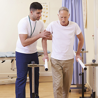 doctor talking to a seated elderly woman